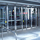 Portes balancées en verre avec portes automatisées pour personnes à mobilité restreinte.